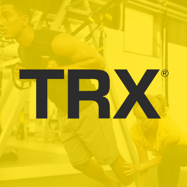 TRX - Heartbeat Fitness Repair A person using TRX equipment with a trainer offering assistance.